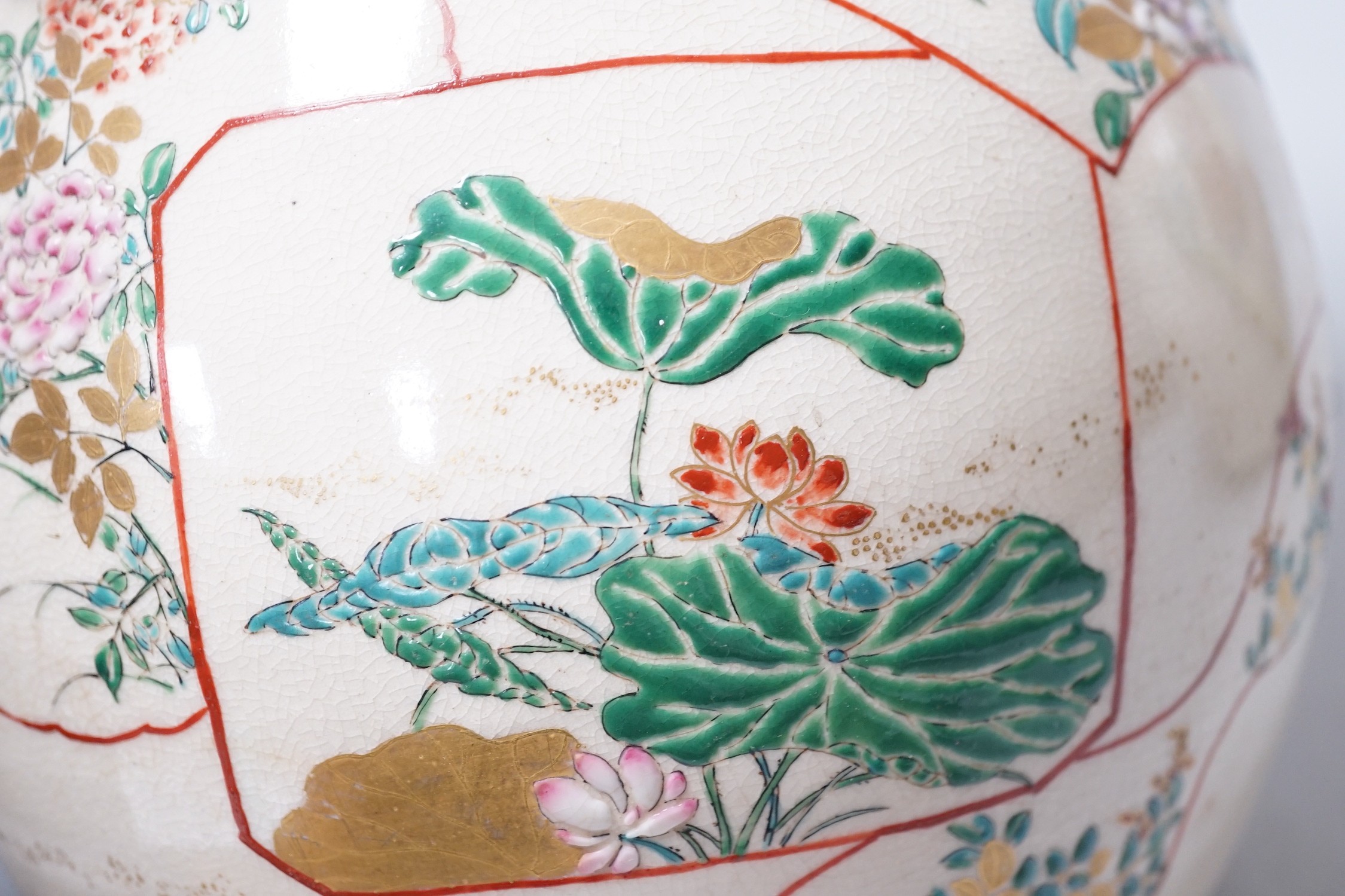 A pair of large late 19th century Satsuma pottery gourd shaped vases, each modelled with a gourd vine, 33cm tall
